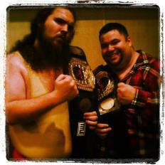 The Big Lovable Team after winning the NCW Tag Team Championship (2012)